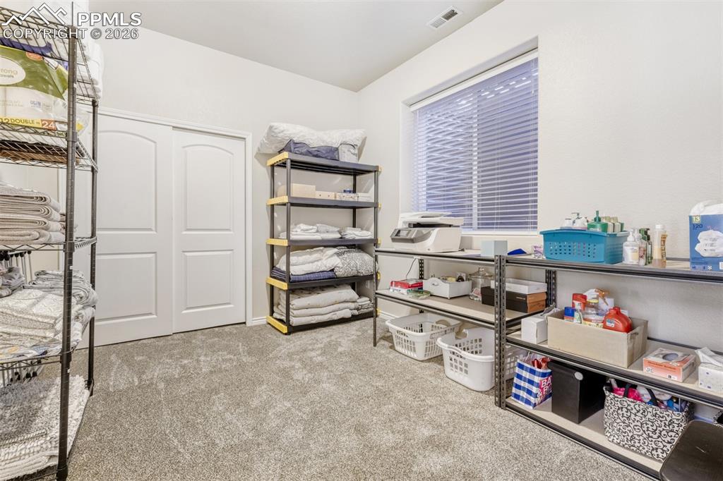 Image 33 of 47: 5th bedroom used as storage in the basement  