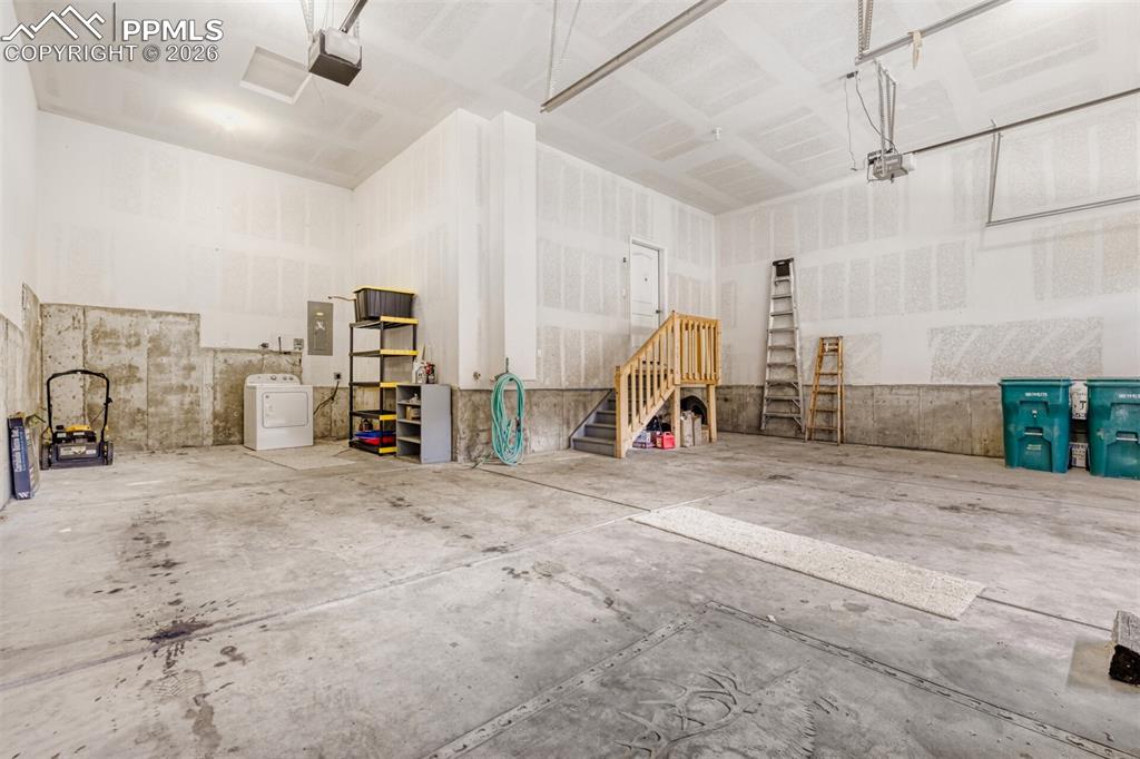 Image 35 of 47: Four car garage with overhead door automatic openers and plenty of space 