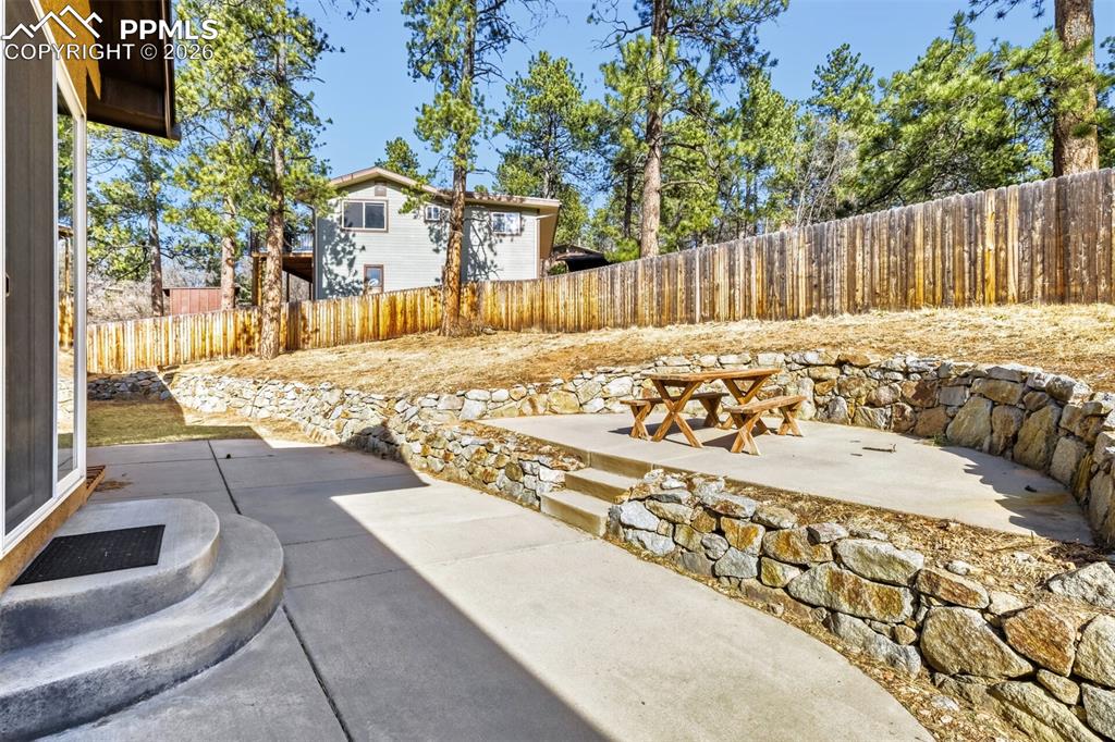 Image 37 of 47: Fenced backyard featuring a patio