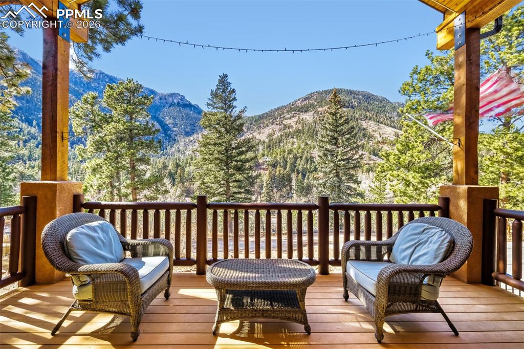 Image 9 of 47: Front covered deck featuring a mountain view