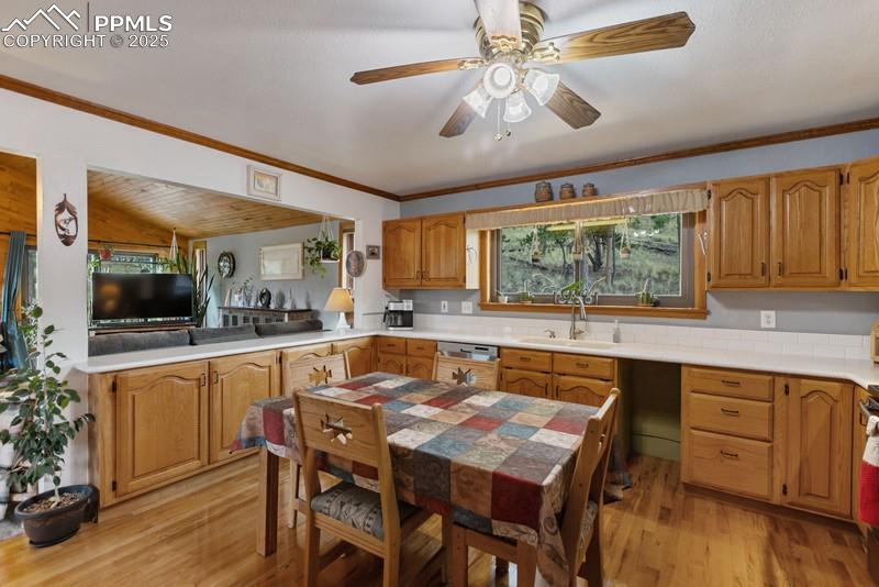Image 23 of 37: Kitchen with light wood finished floors, light countertops, a peninsula, br
