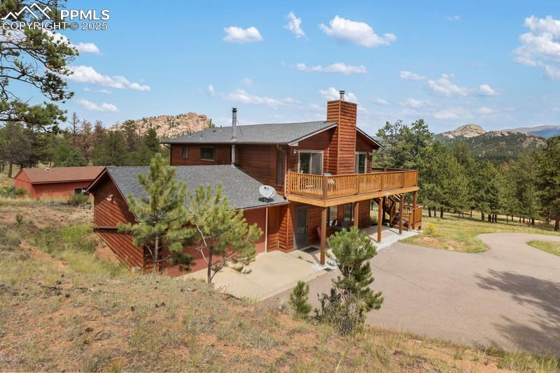 Image 3 of 37: Rear view of property featuring stairway, a deck with mountain view, a shin