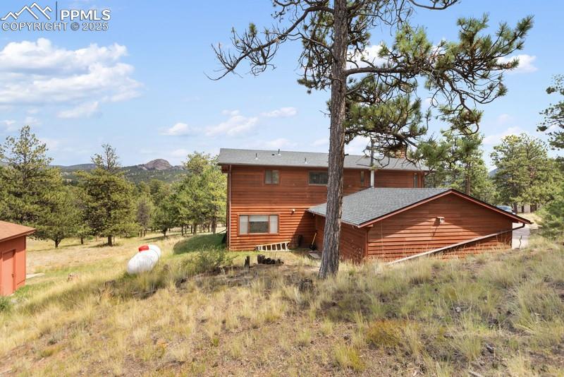 Image 6 of 37: Rear view of house with a rural view