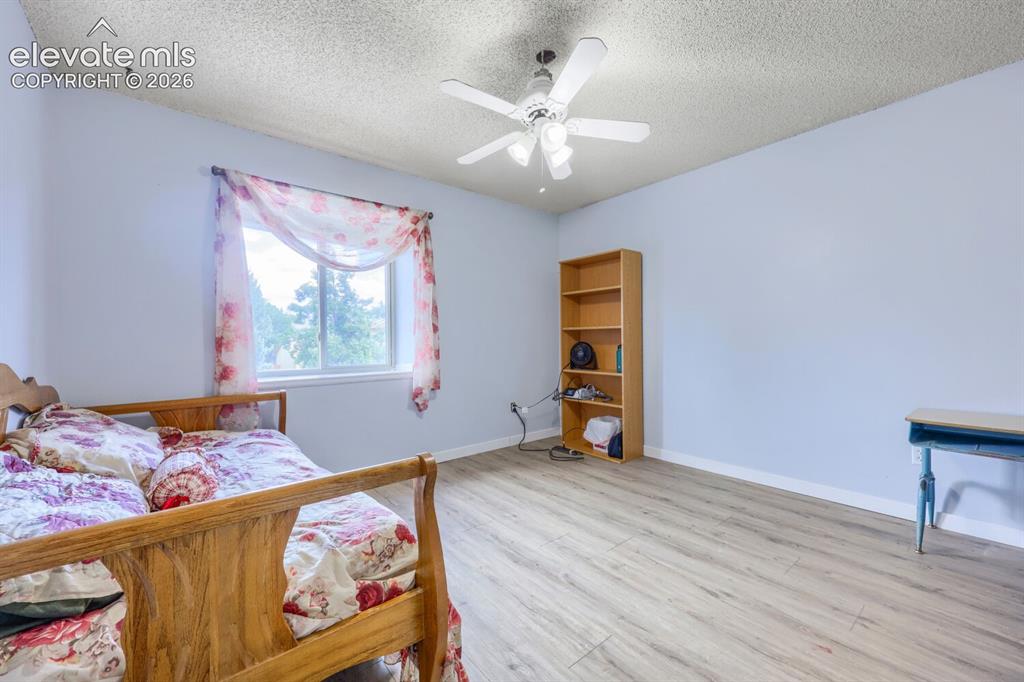 Image 20 of 42: LVP flooring, a ceiling fan with integrated lighting, and a window providin