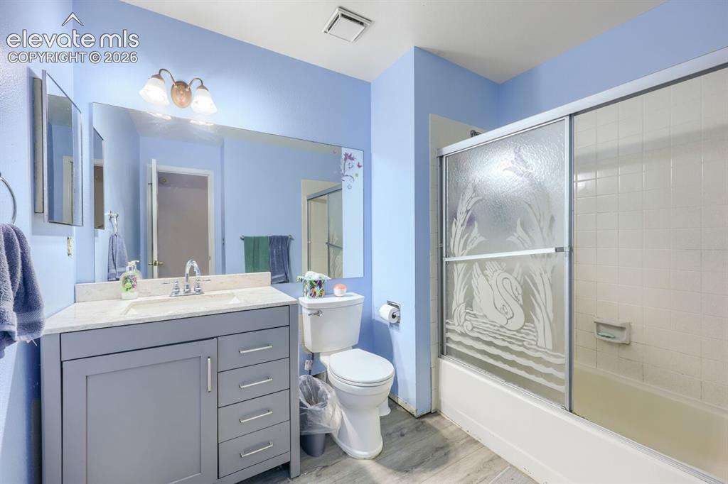 Image 27 of 42: Vanity with a light-colored countertop, integrated sink, and brushed nickel