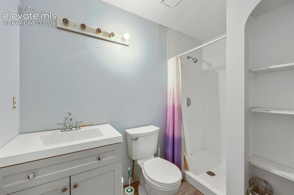 Image 28 of 42: Integrated vanity with a single basin sink, chrome faucet, and lower cabine
