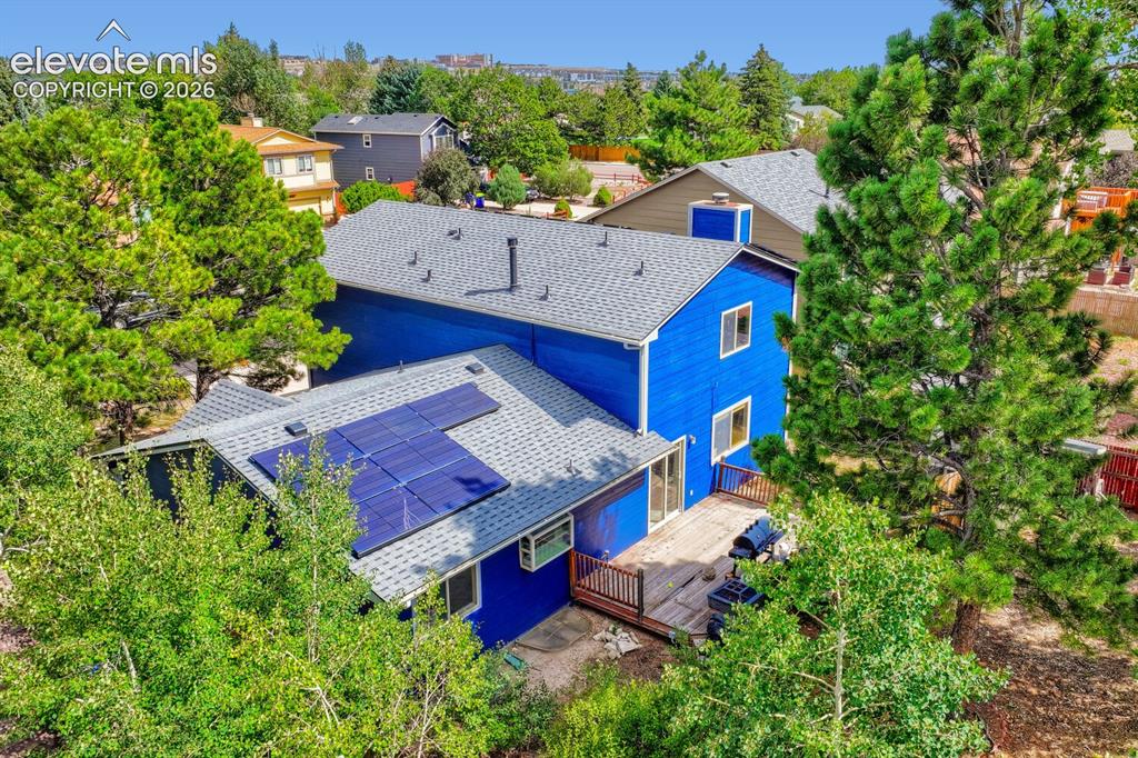 Image 3 of 42: Exterior featuring solar panels, a multi-level roofline with shingle roofin