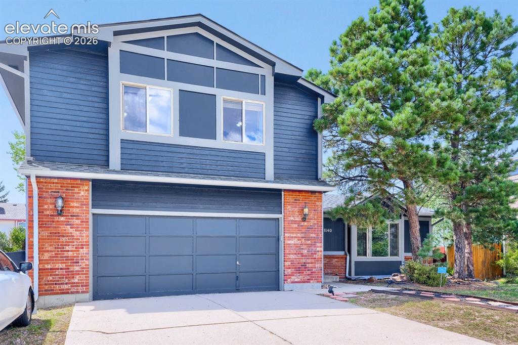 Image 3 of 42: Two-story exterior with horizontal siding and brick detailing