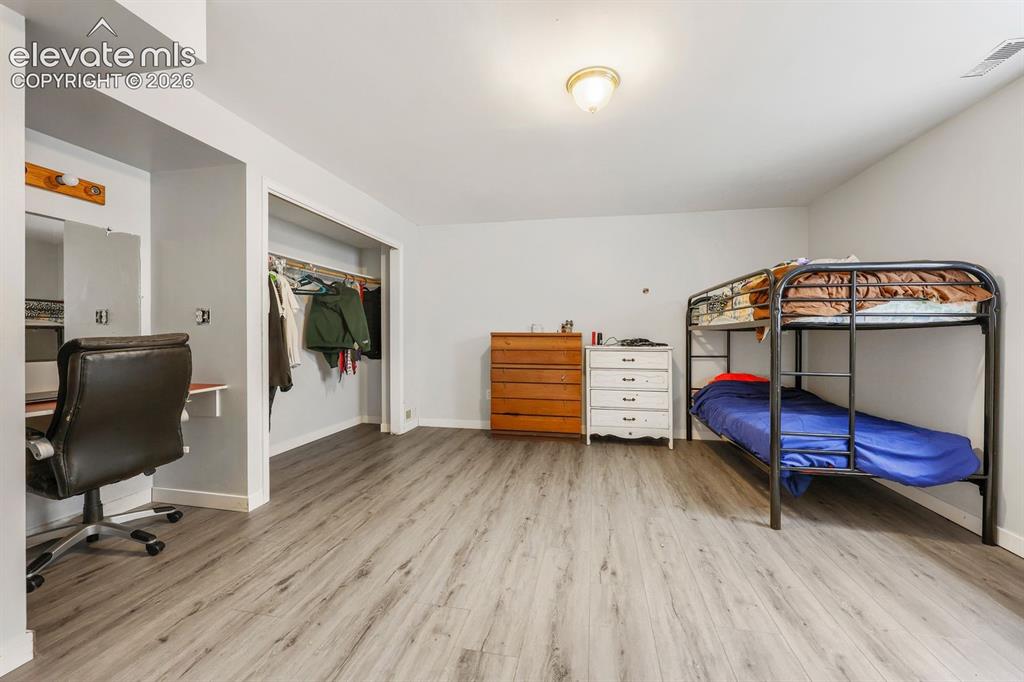 Image 33 of 42: Room featuring wood-finish flooring, recessed lighting, and a built-in clos