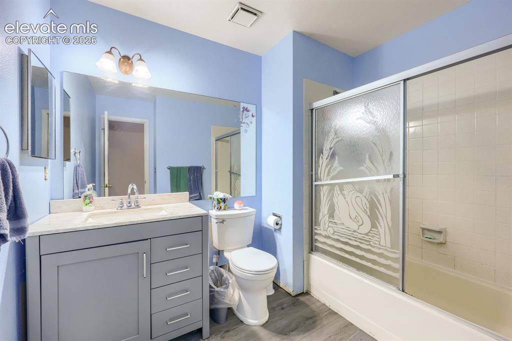 Image 36 of 42: Vanity with stone-finish countertop, single basin sink, and chrome faucet