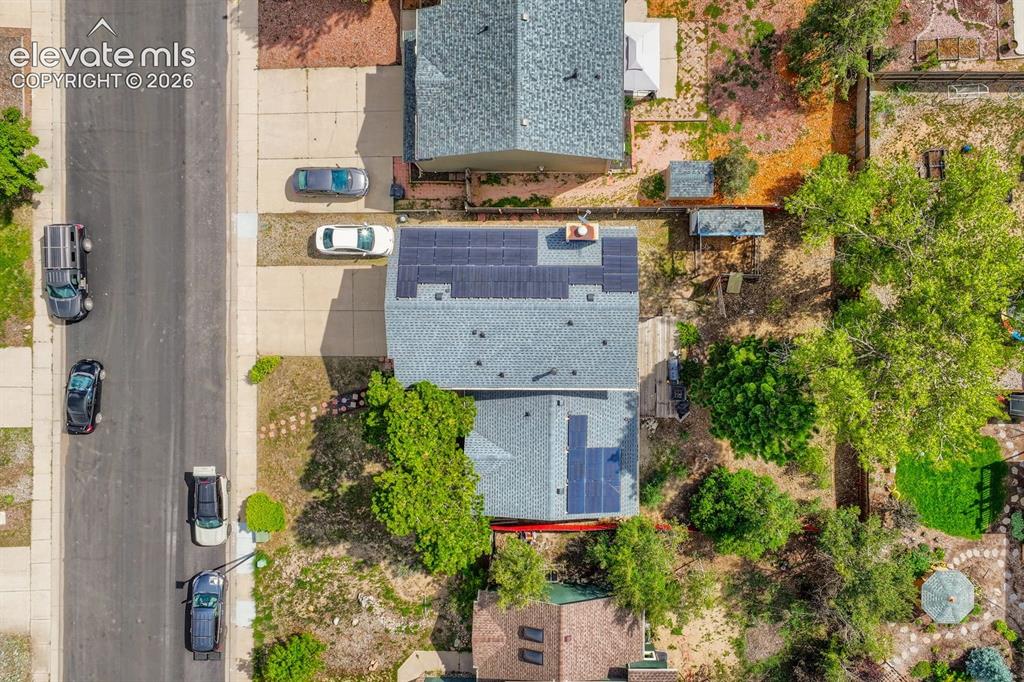 Image 8 of 42: Residential property featuring a shingled roof, solar panel installations,