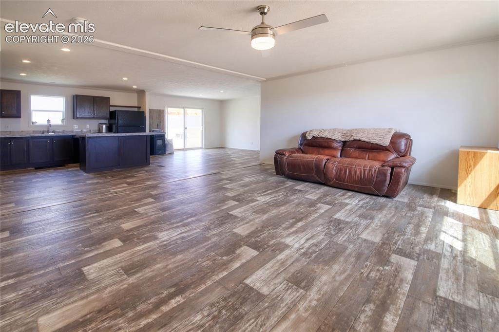 Image 14 of 50: Living room with ceiling fan