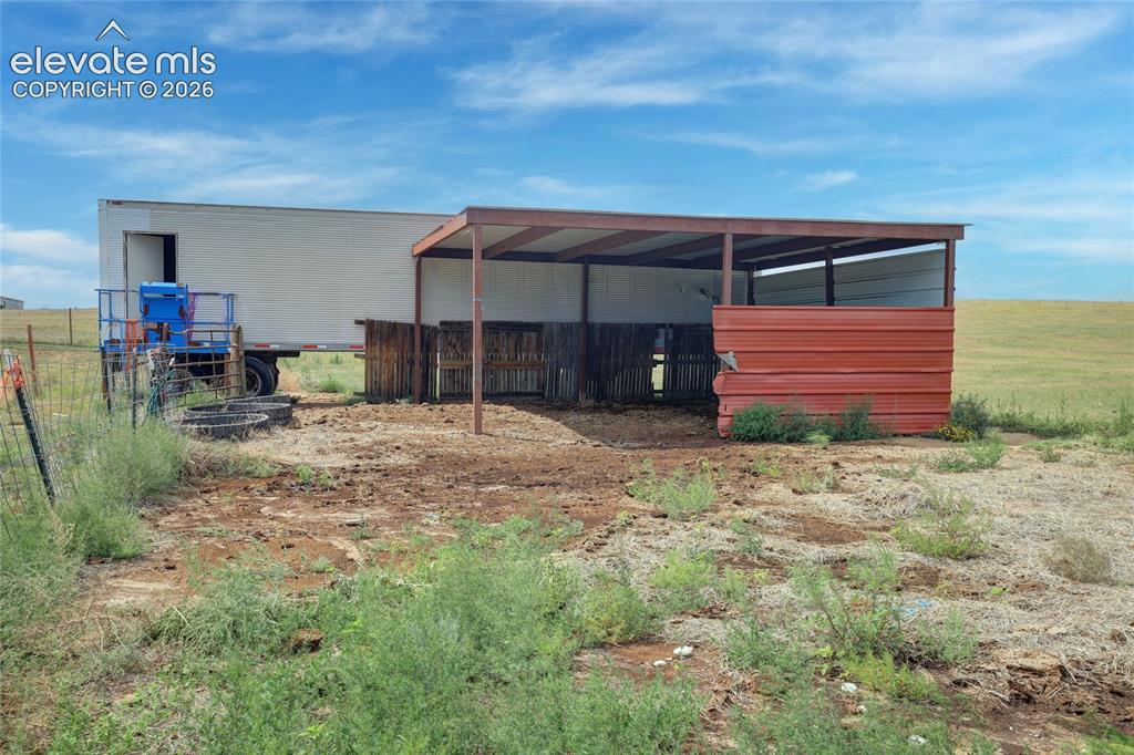 Image 30 of 50: Covered area for animals and truck for hay storage