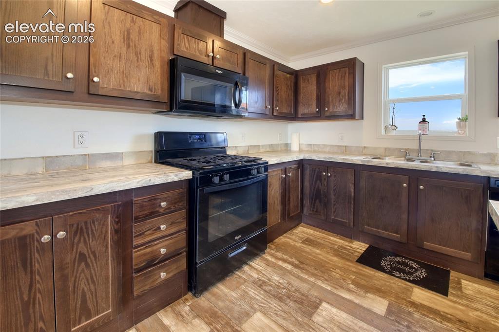 Image 5 of 50: Kitchen features tons of cabinetry and counter space