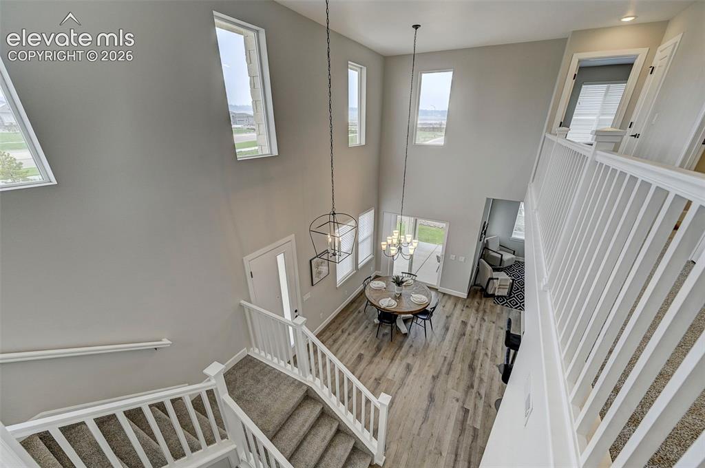 Image 24 of 37: The stairwell opens to the upper loft and looks down on the main floor belo