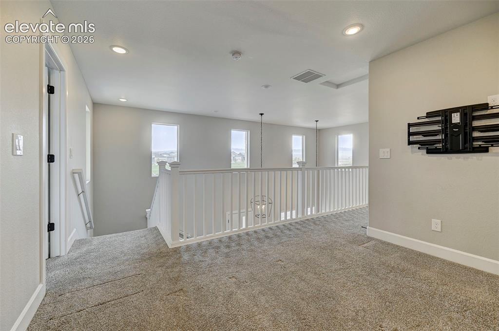 Image 25 of 37: Upstairs is an open and spacious loft, perfect for a play area, office, hom