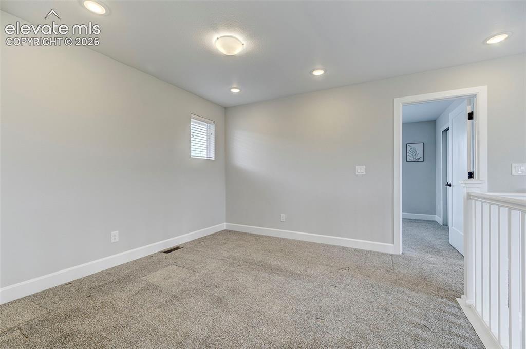 Image 27 of 37: The loft is adjacent to the second bedroom on the upper level. 