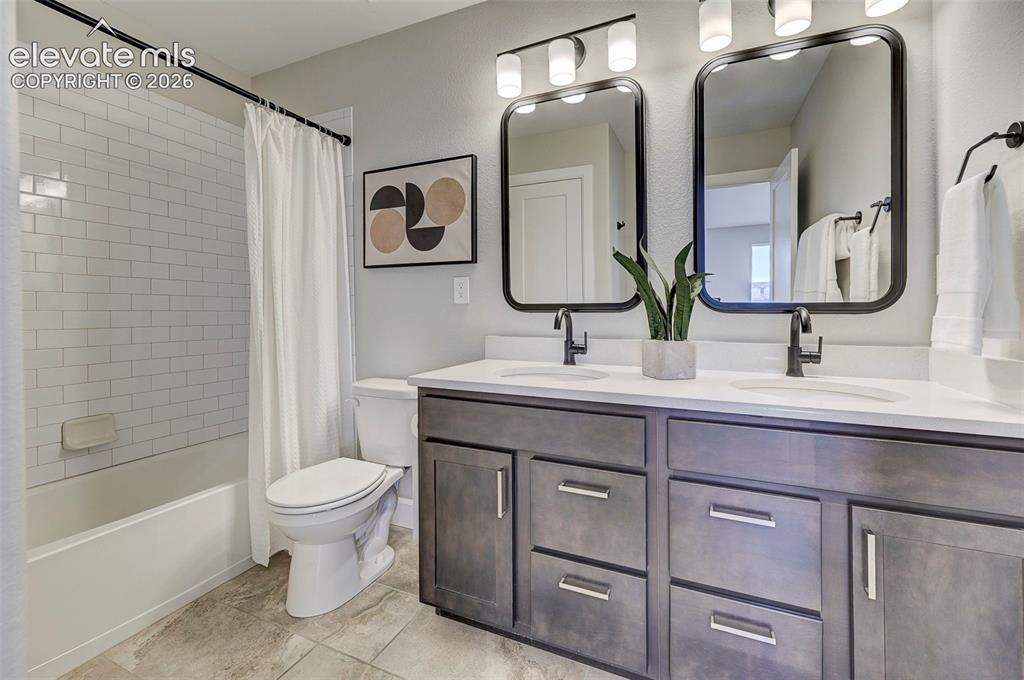 Image 30 of 37: This upstairs bathroom serves the two upstairs bedrooms and features quartz