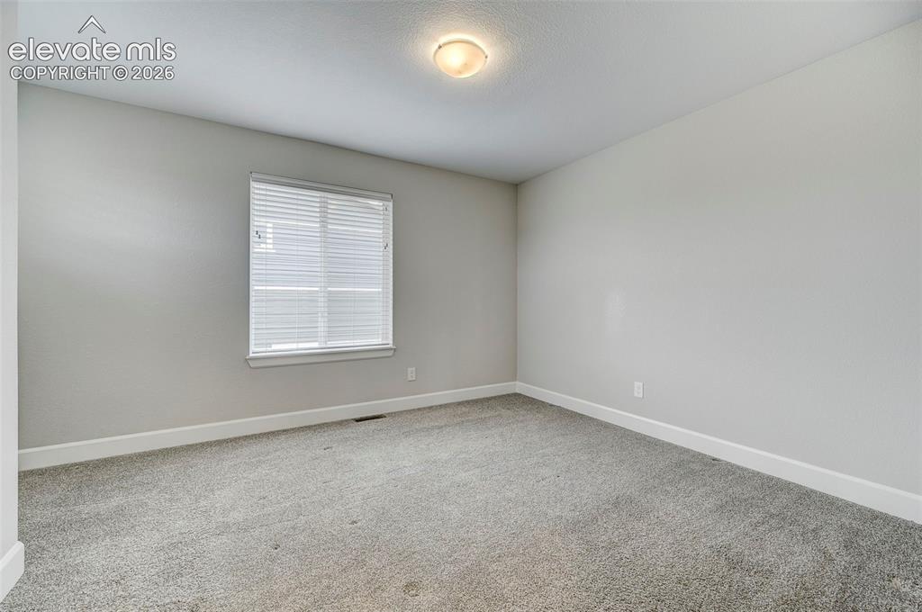 Image 31 of 37: The third bedroom is located upstairs and is adjacent to the upstairs bath.