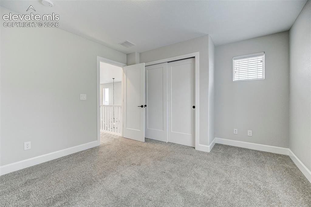 Image 32 of 37: The third bedroom is bright and spacious and features a double reach-in clo