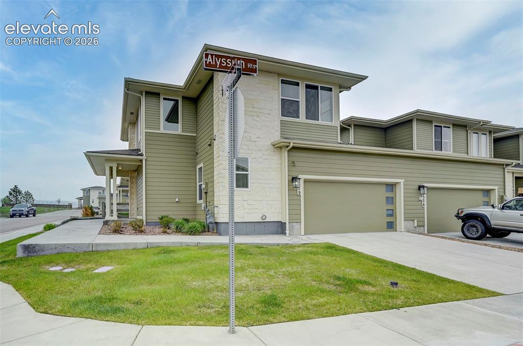 Image 34 of 37: Stone accents and soft coloring give this home great curb appeal. The corne