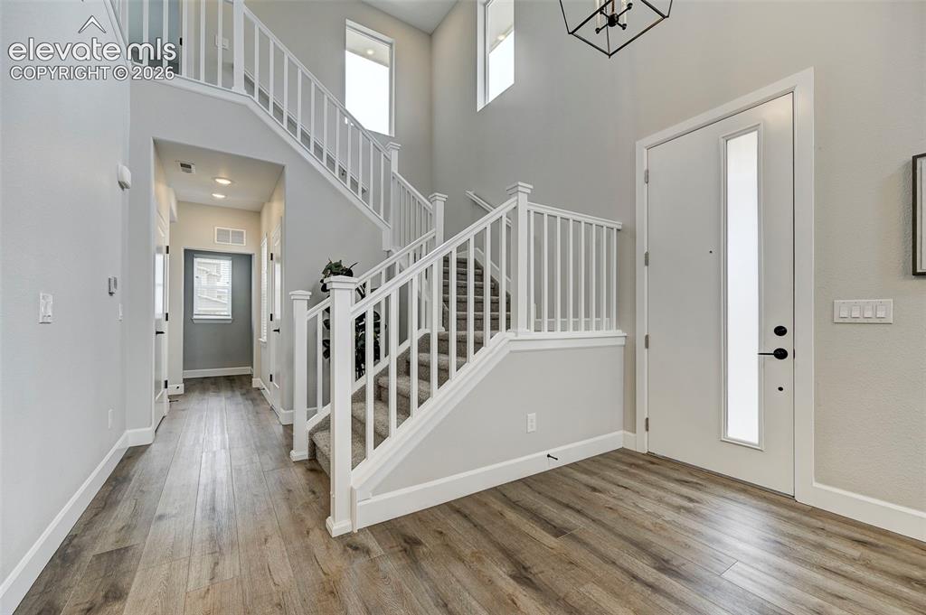 Image 5 of 37: The staircase is a grand focal point for the home