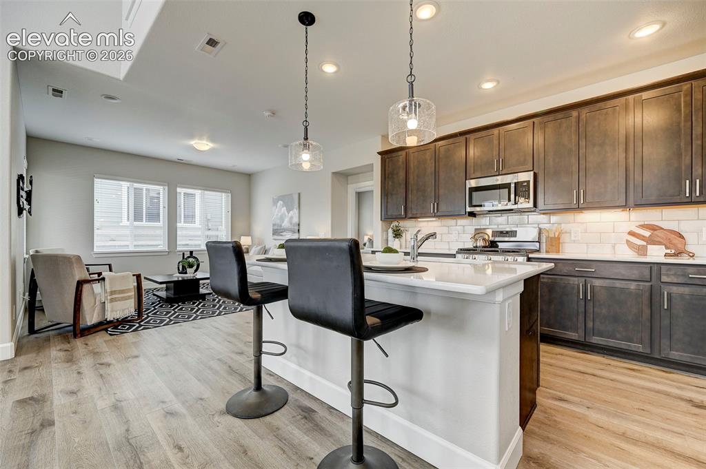 Image 8 of 37: Island seating and lots of counter space make the kitchen an elegant space 