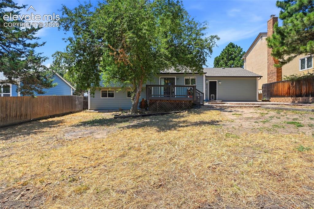 Image 38 of 50: Expansive backyard featuring a wood privacy fence, a multi-level wood deck,