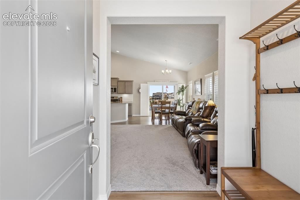 Image 12 of 35: Covered entry has space for coats and shoes.