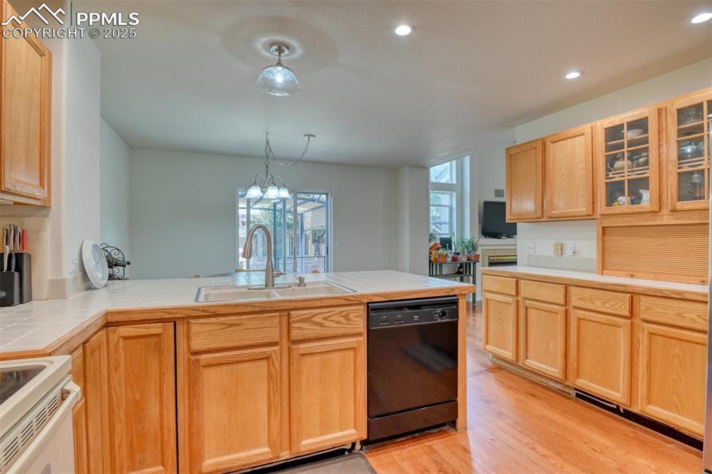 Image 10 of 43: Kitchen featuring light brown cabinets, light wood-style flooring, dishwash
