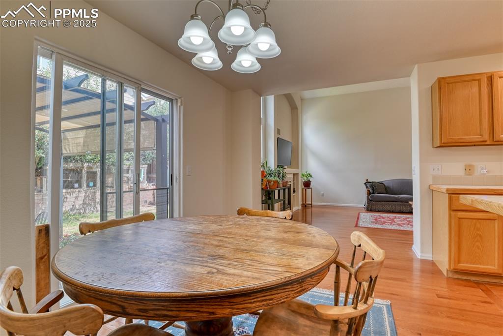 Image 13 of 43: Dining space with light wood-style flooring and a chandelier