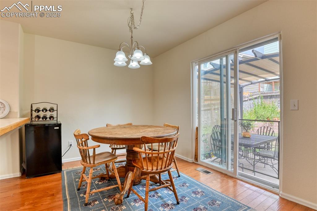 Image 14 of 43: Dining space with light wood-type flooring and a chandelier