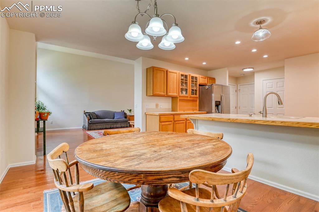 Image 16 of 43: Dining room featuring recessed lighting, light wood-type flooring, and a ch