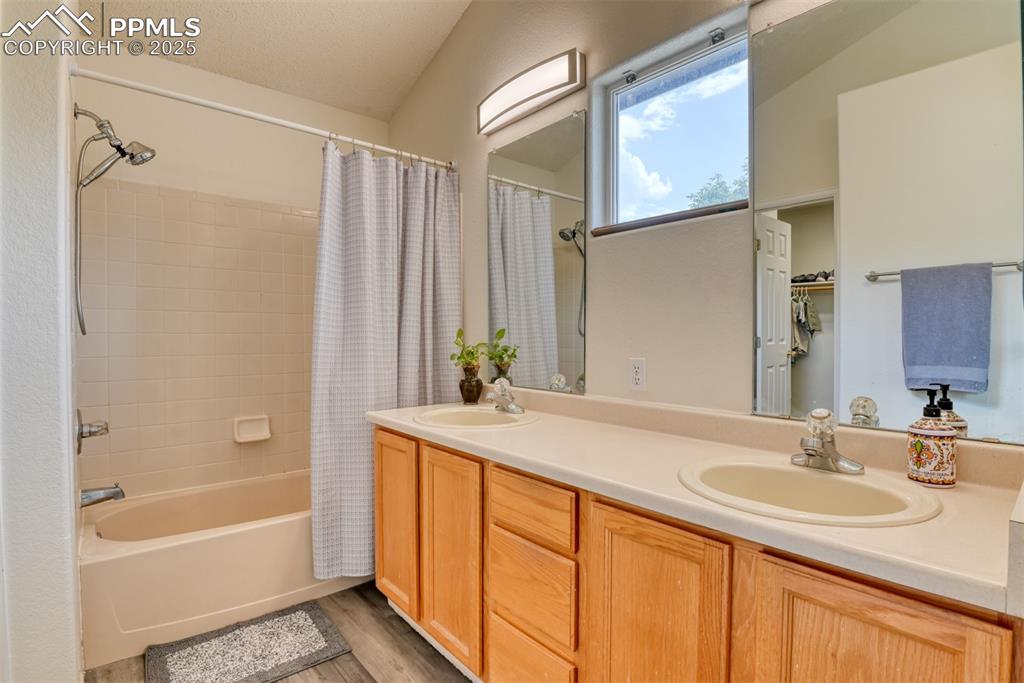 Image 22 of 43: Bathroom featuring shower / bath combo, new floors, new light fixtures