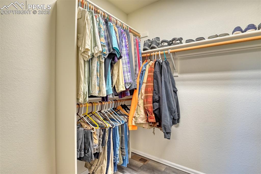 Image 25 of 43: Walk in closet featuring new flooring