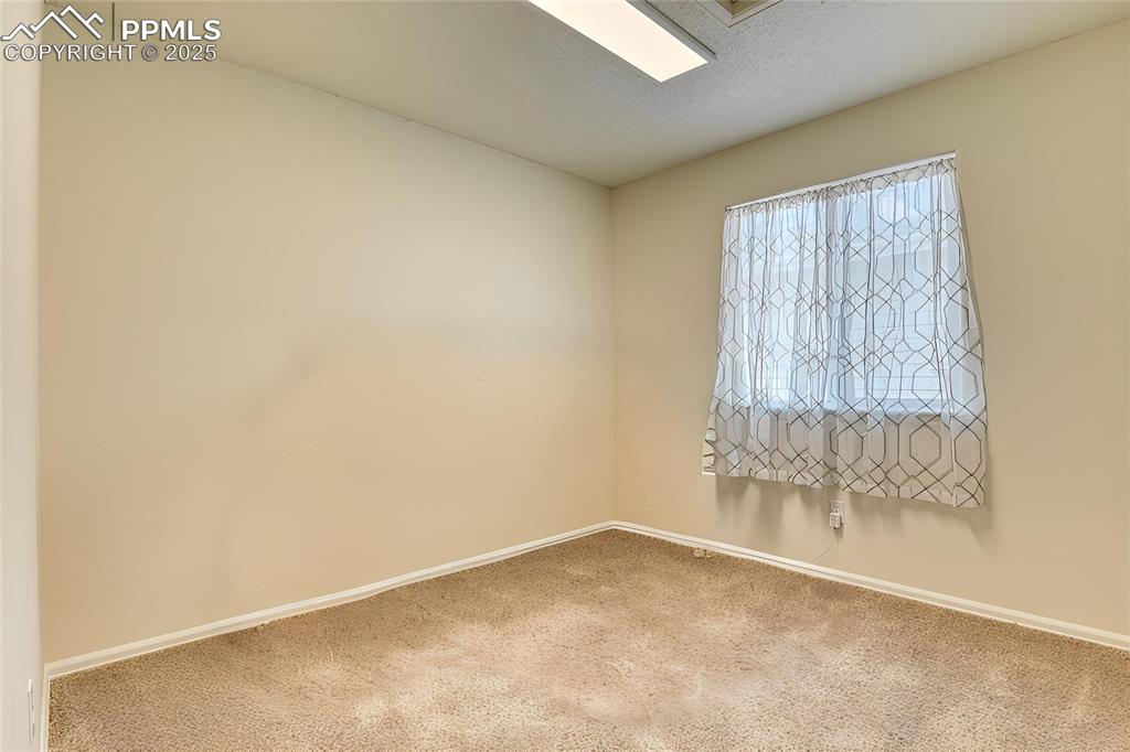 Image 28 of 43: Spare bedroom with fresh paint and new carpet