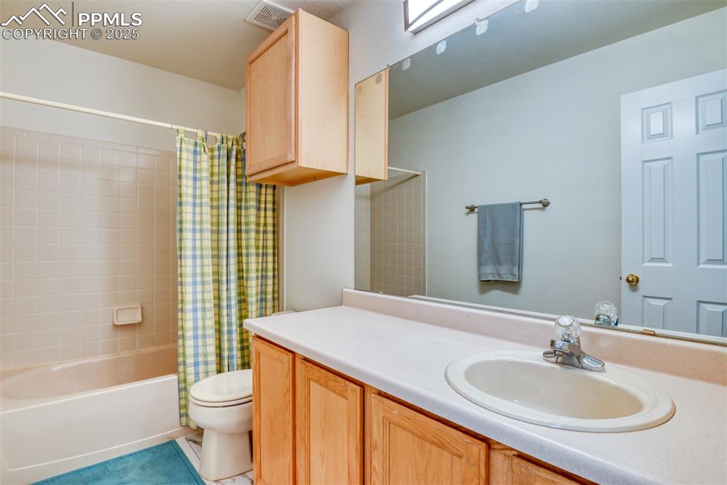 Image 30 of 43: Full bath with shower / bath combo, and vanity