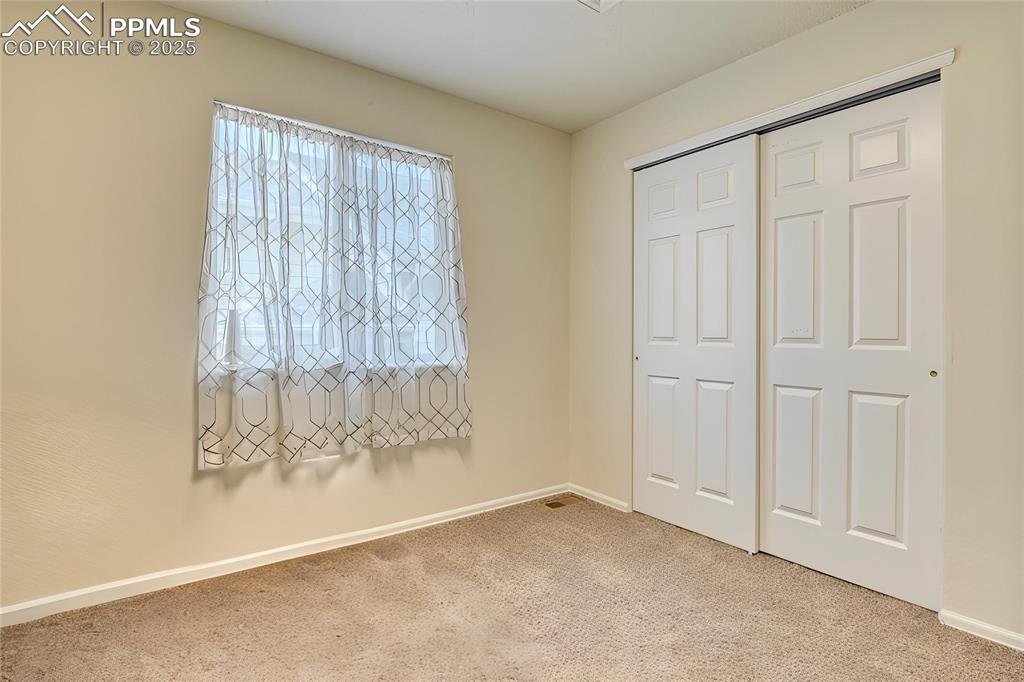 Image 31 of 43: Spare bedroom with closet, fresh paint and new carpet