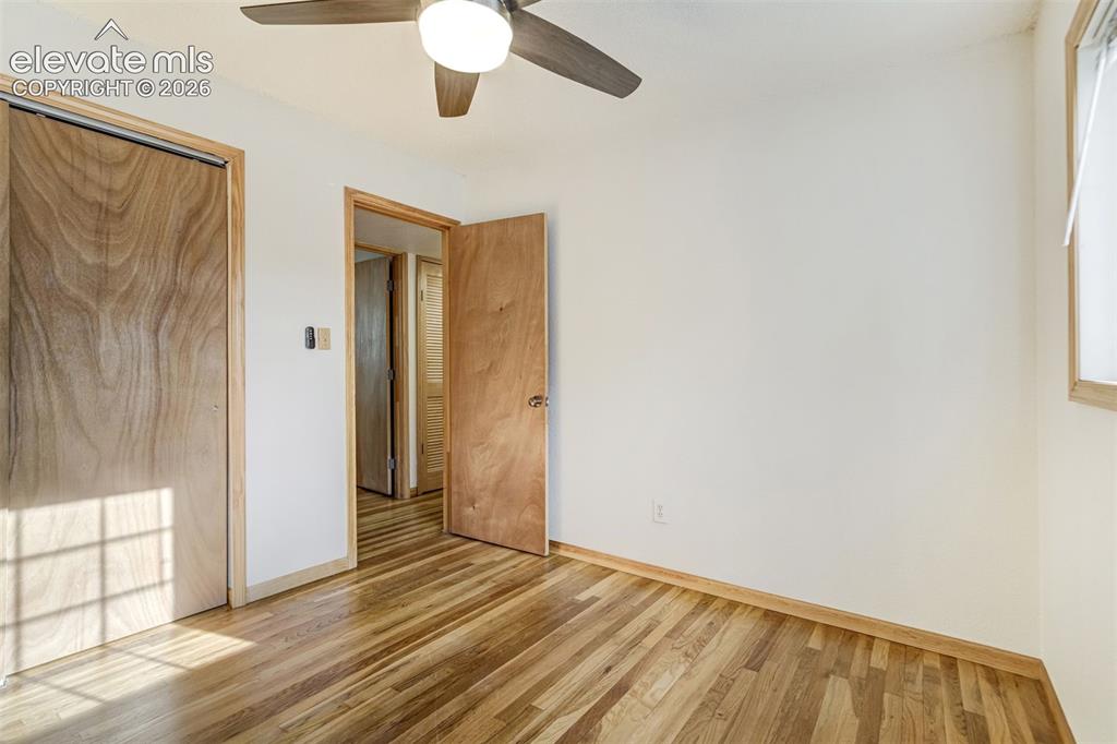 Image 19 of 31: Hardwood flooring complemented by wood-finish doors and trim