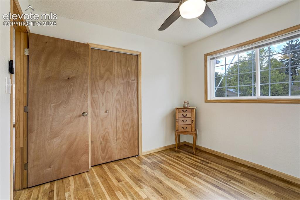 Image 21 of 31: Hardwood-finish flooring, wood-toned interior doors, built-in bi-fold close