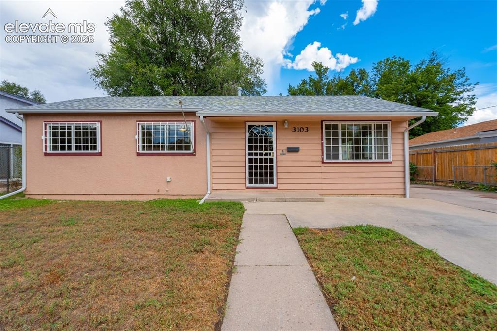 Image 3 of 31: Ranch-style exterior with stucco and horizontal siding, multiple windows wi