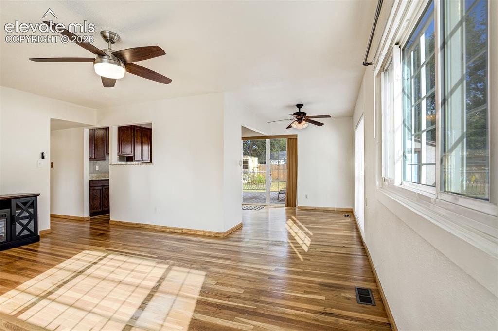 Image 8 of 31: Wood-finish flooring throughout, multiple ceiling fans with integrated ligh