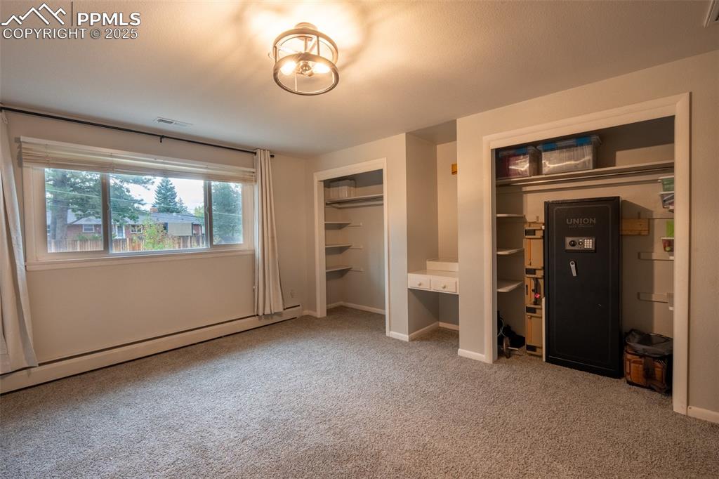 Image 18 of 49: Bedroom 2 with dual closets - upper floor