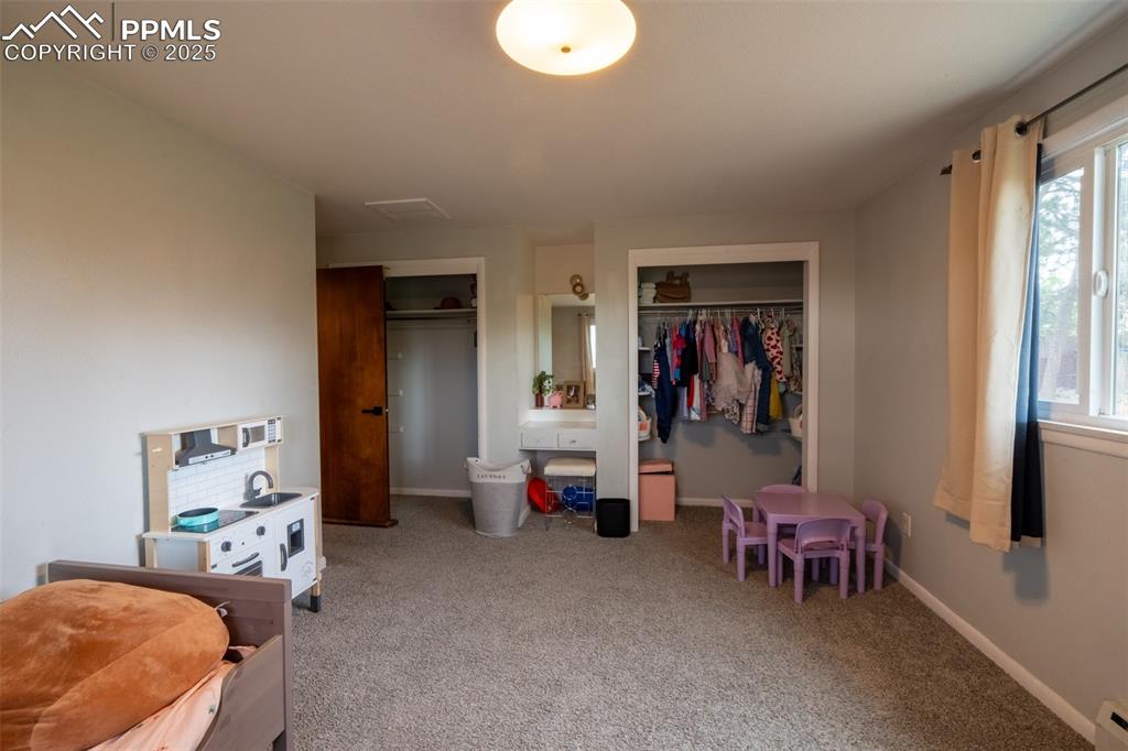 Image 20 of 49: Bedroom 3 with dual closets - upper floor