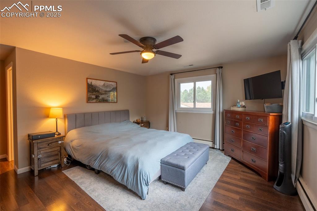 Image 24 of 49: Bedroom 4 (primary) with attached primary 3/4 bath and dual closets - upper