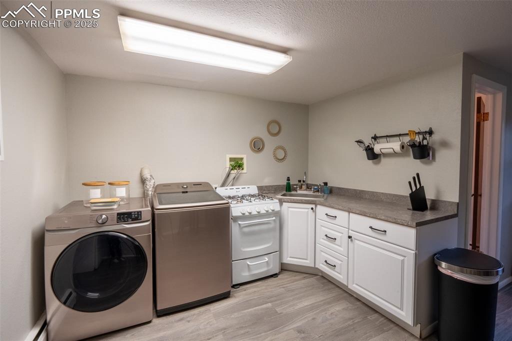 Image 30 of 49: Second kitchen and laundry - lower level (currently being used as an air B&
