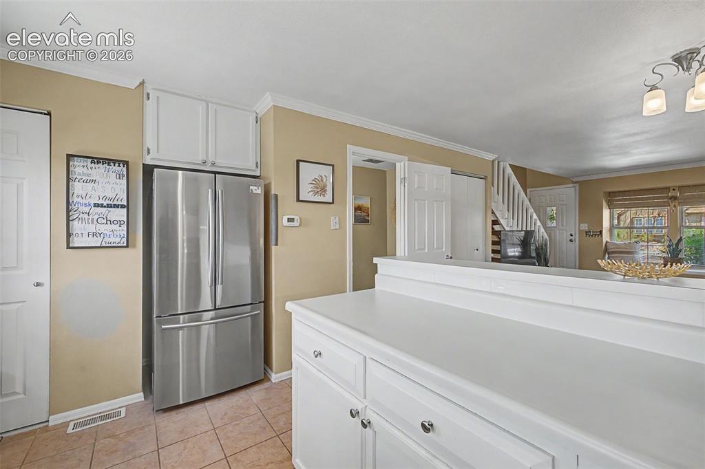 Image 15 of 31: Kitchen featuring light cabinets and counters and stainless steel appliance