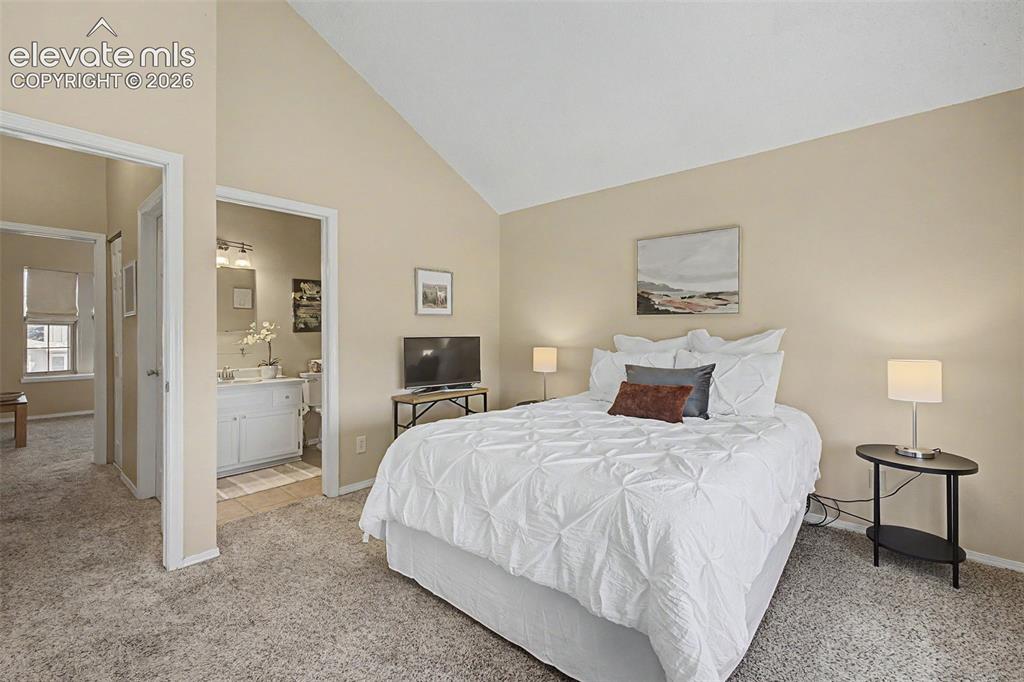 Image 19 of 31: Primary bedroom with en suite bathroom