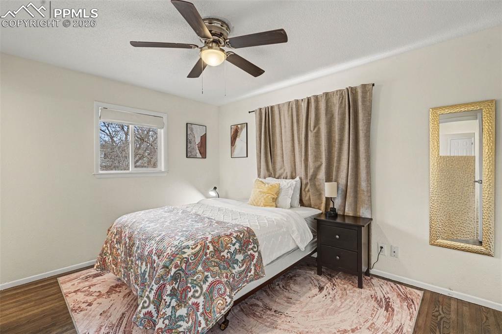 Image 8 of 23: Bedroom with wood finished floors, and ceiling fan