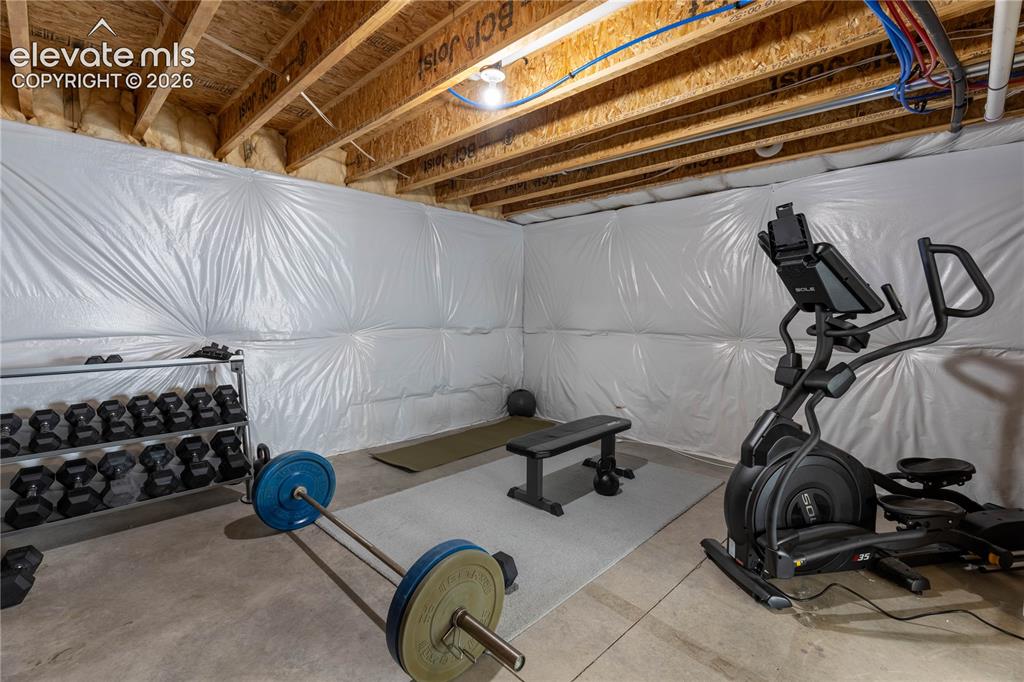 Image 27 of 37: Unfinished basement with exposed ceiling joists and concrete flooring